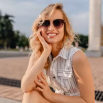 young-attractive-cute-stylish-blonde-woman-sitting-city-street-summer-fashion-style-white-cotton-dress-wearing-sunglasses_285396-8528